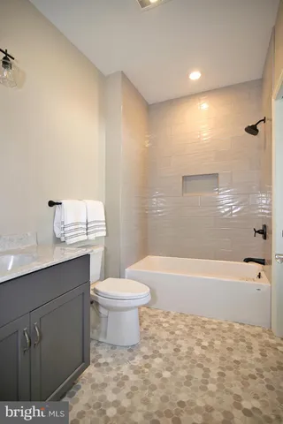 a bathroom with a sink a toilet and bathtub
