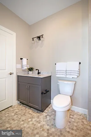 a bathroom with a toilet a sink and mirror