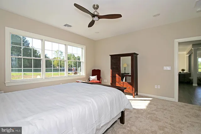 a bedroom with a large bed and a large window