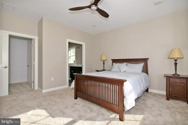 a bedroom with a bed and a lamp