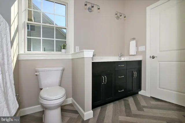 a bathroom with a toilet sink and mirror