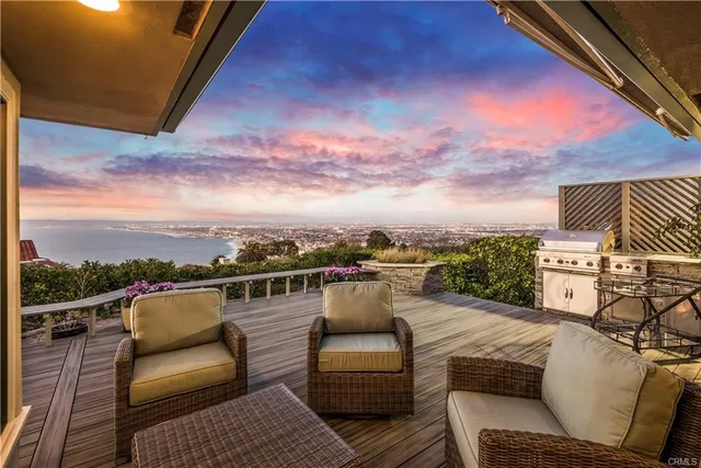 a kitchen with stainless steel appliances a dining table chairs refrigerator and sink