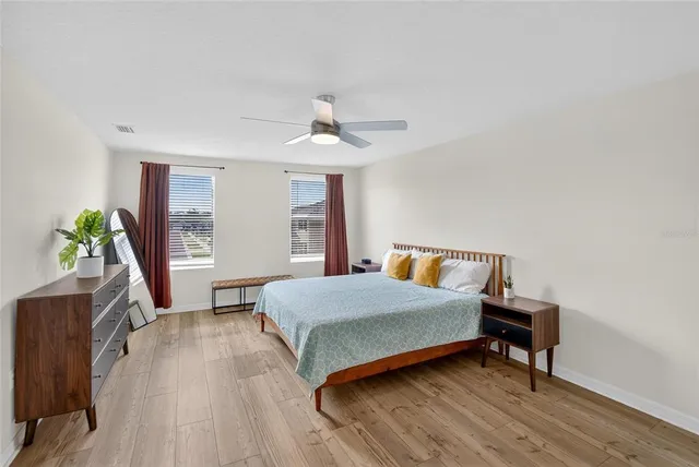 a bedroom with a bed and a chandelier