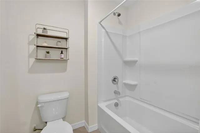 a bathroom with a toilet and a bathtub