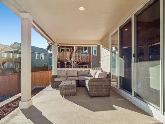 a living room with a couch and a glass door