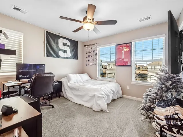 a bedroom with a large bed and a window