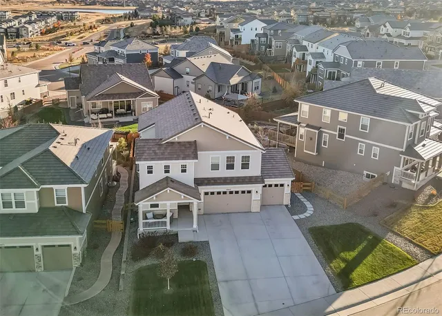 an aerial view of residential houses with outdoor space and parking