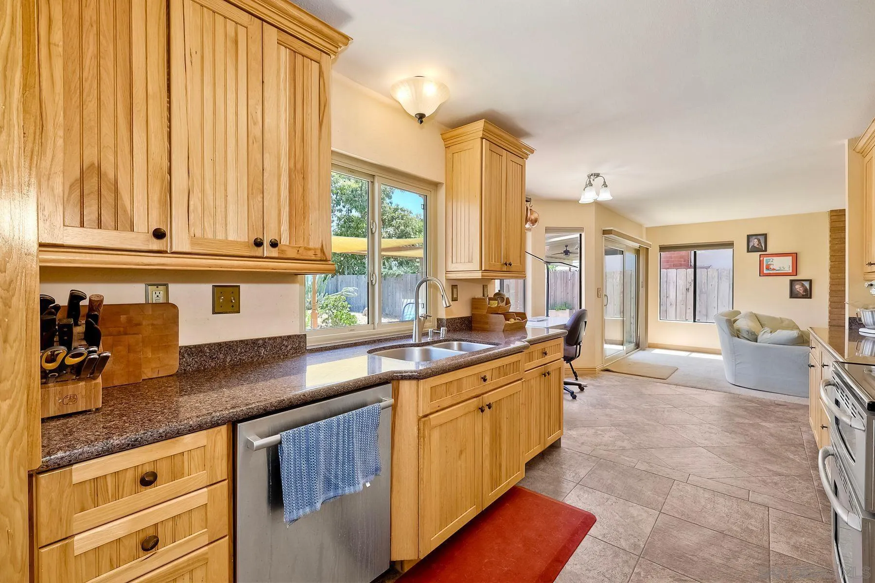 3805 Catamarca Drive San Diego, CA 92124 - Photo 11 of 59 a kitchen with granite countertop a sink and a counter top space