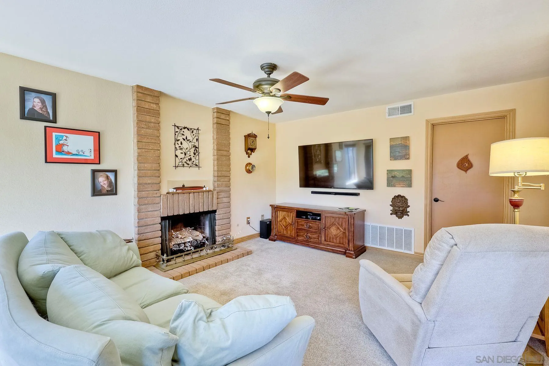 3805 Catamarca Drive San Diego, CA 92124 - Photo 14 of 59 a living room with furniture a flat screen tv and a fireplace