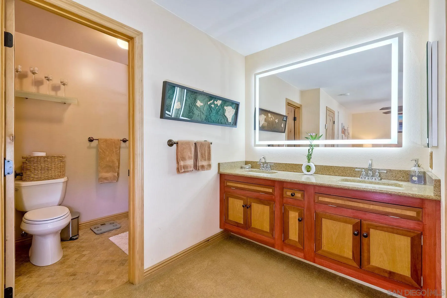 3805 Catamarca Drive San Diego, CA 92124 - Photo 21 of 59 a spacious bathroom with a toilet sink and mirror