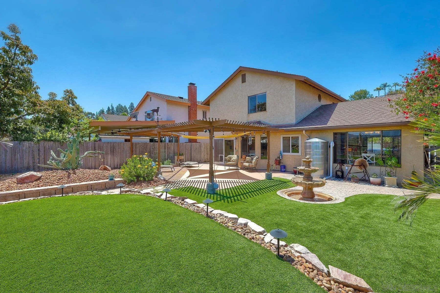 3805 Catamarca Drive San Diego, CA 92124 - Photo 29 of 59 a front view of a house with swimming pool and chairs