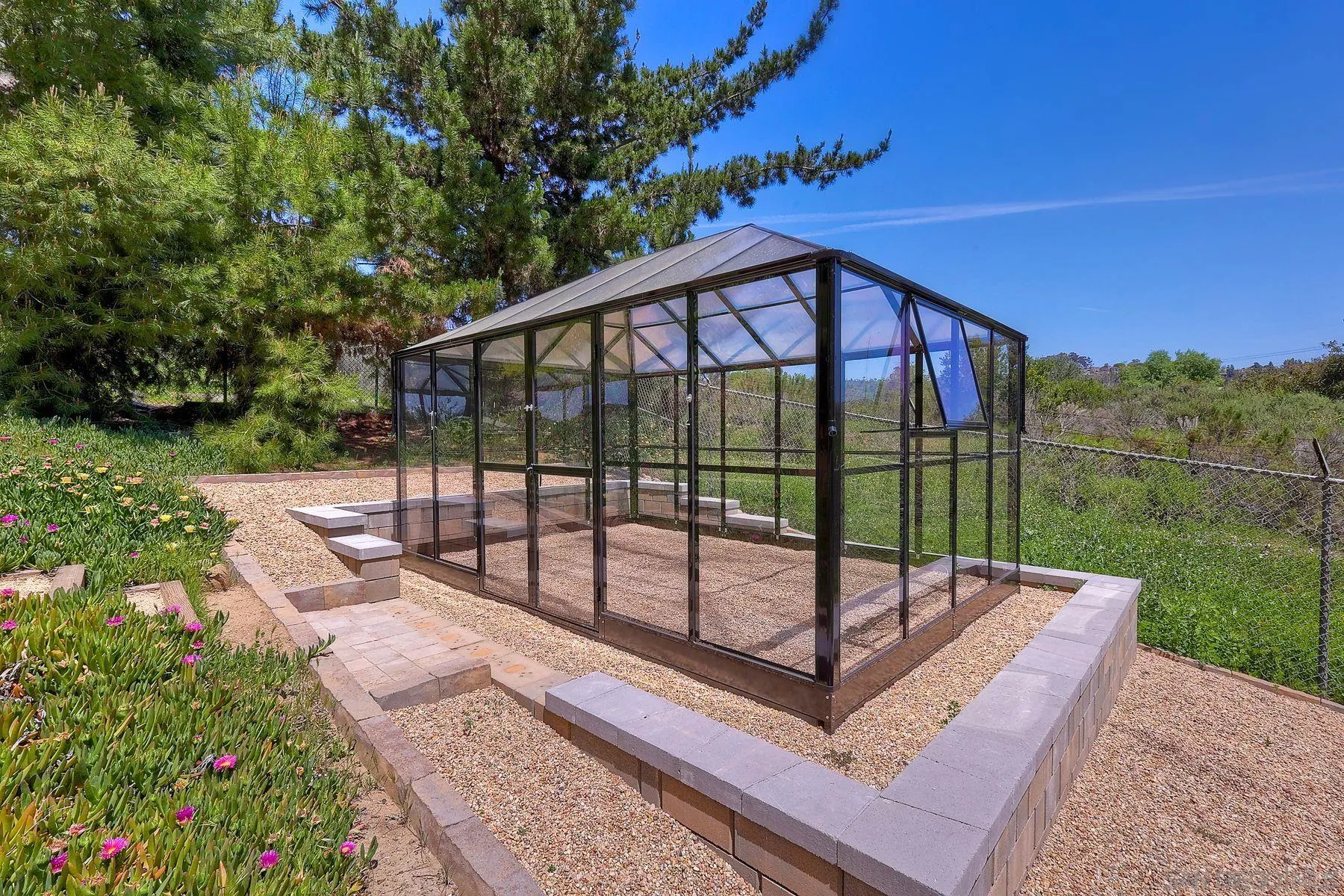 3805 Catamarca Drive San Diego, CA 92124 - Photo 34 of 59 a view of a backyard with a garden and deck