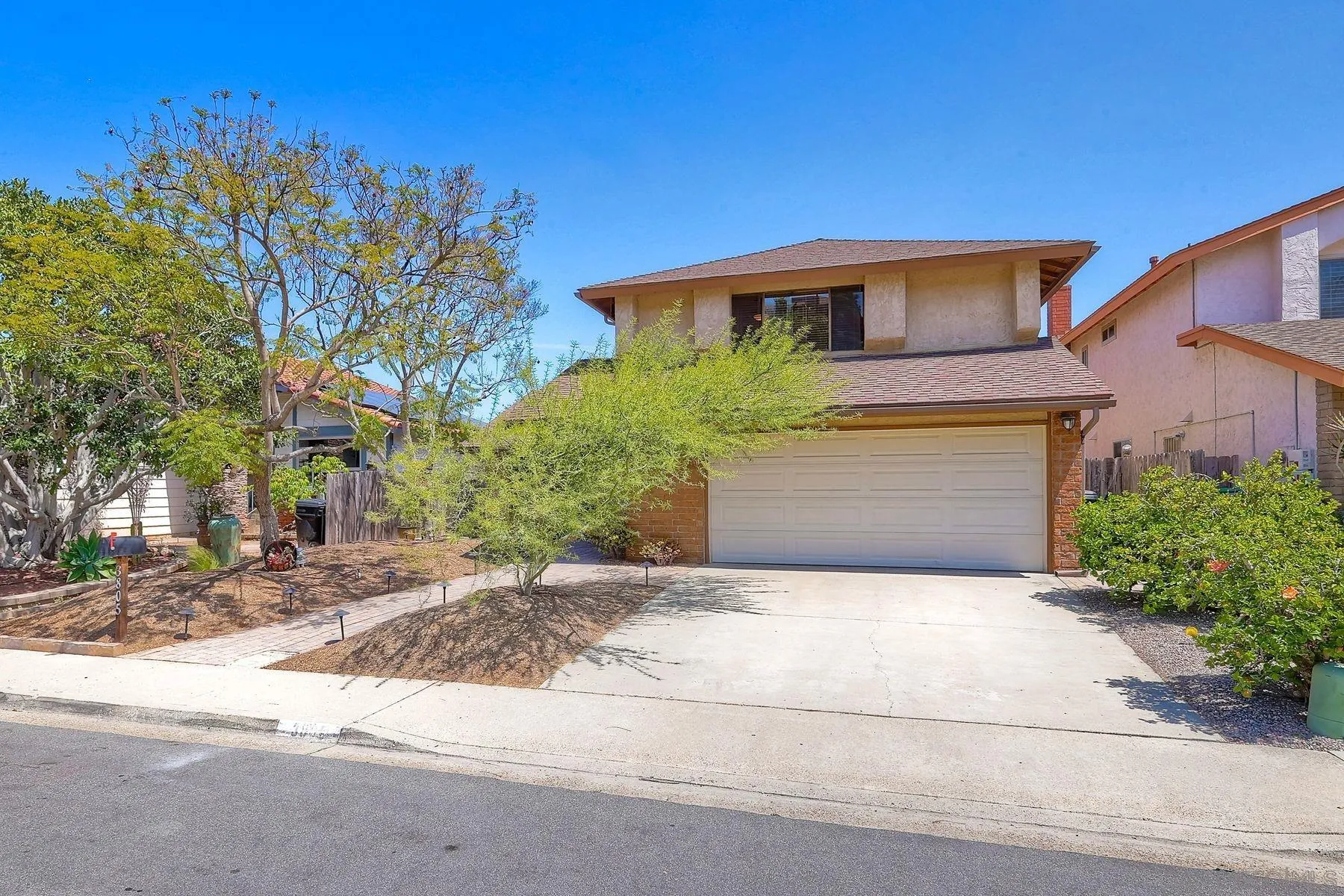 3805 Catamarca Drive San Diego, CA 92124 - Photo 53 of 59 a front view of a house with a yard and garage
