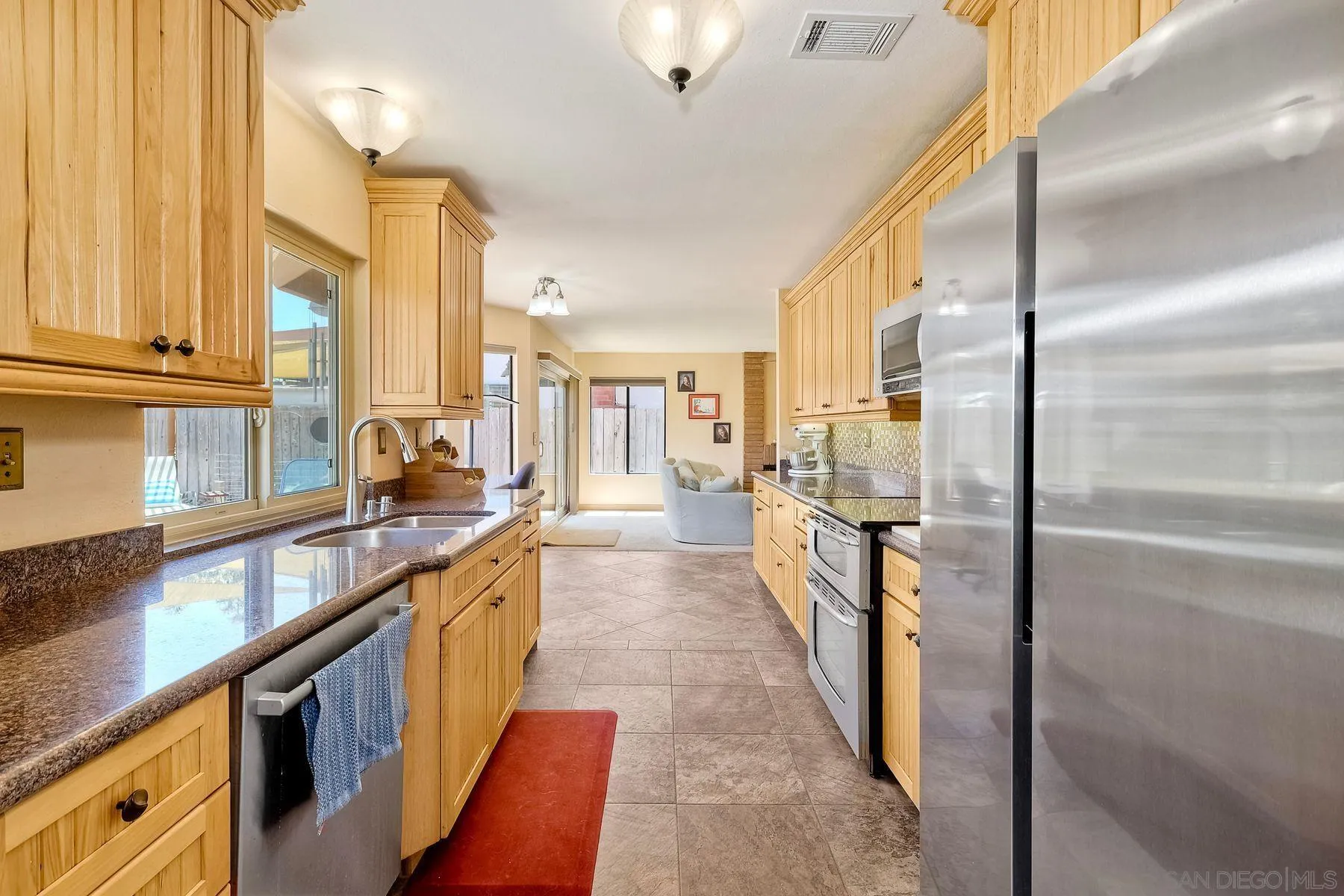3805 Catamarca Drive San Diego, CA 92124 - Photo 10 of 59 a kitchen with stainless steel appliances granite countertop a refrigerator a stove and a sink