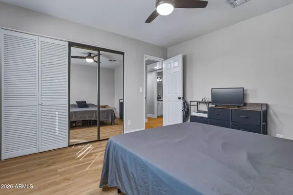 a bedroom with a bed and a television