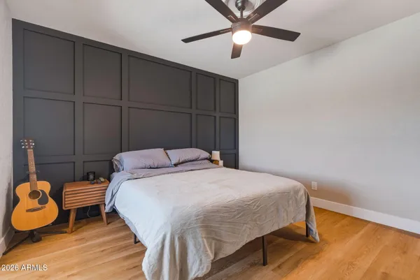 a bedroom with a bed and wooden floor