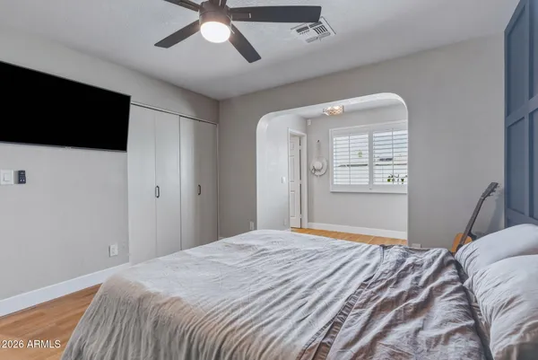 a bedroom with a large bed and a flat screen tv