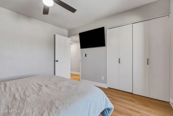 a bedroom with a bed and a flat screen tv