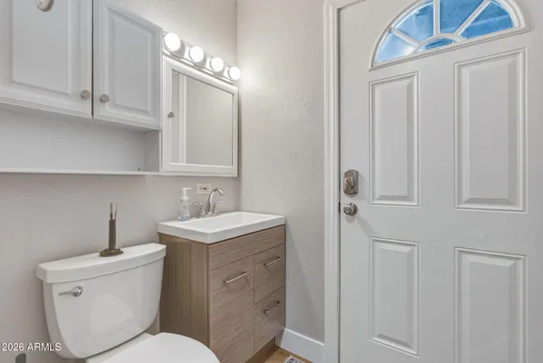 a bathroom with a toilet sink and mirror