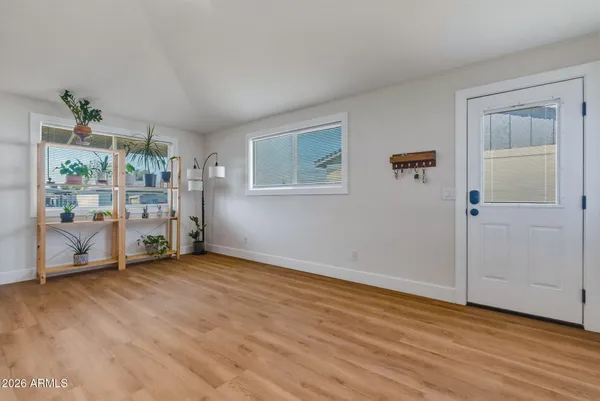 a view of an empty room with window and closet area
