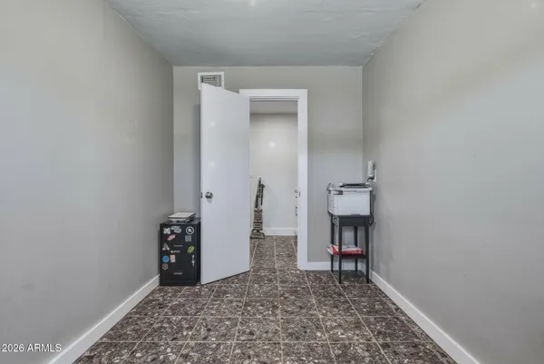 a view of empty room with baby crib
