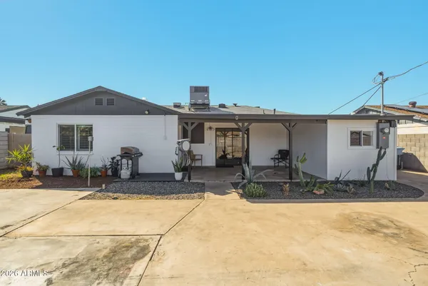 a front view of house with yard and seating space