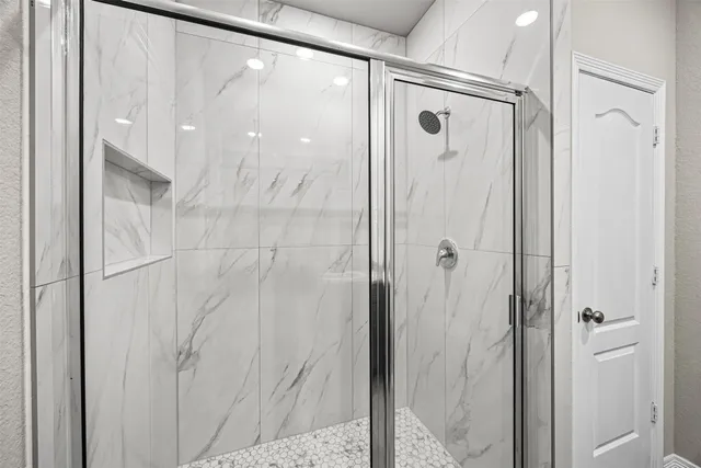 a bathroom with a glass shower door