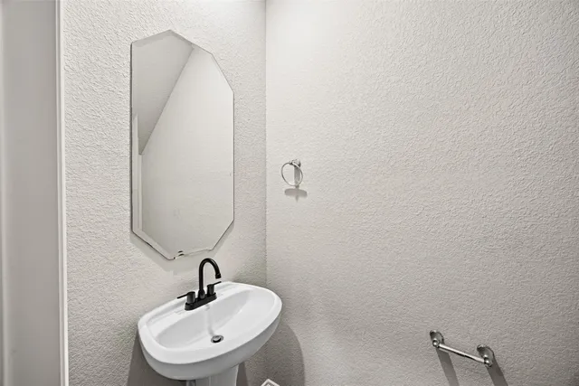 a bathroom with a sink and mirror