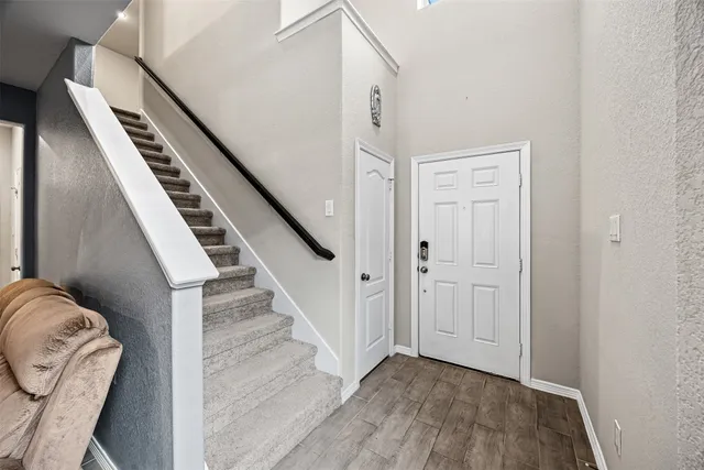 a view of an entryway with wooden floor