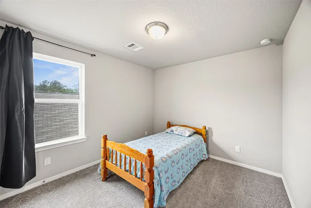 a bedroom with a bed and window