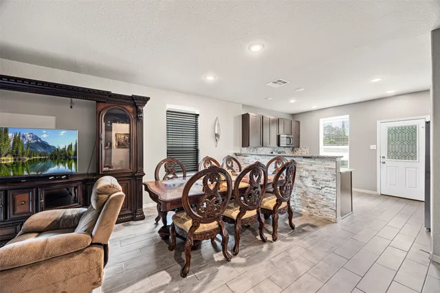 a very nice looking dining room with furniture window and outside view