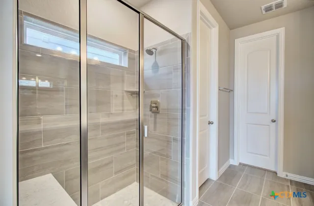 a bathroom with a glass shower door