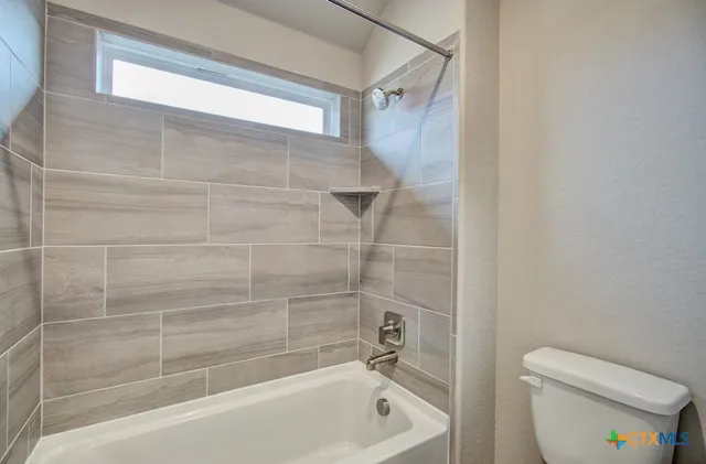 a bathroom with a bathtub and a toilet