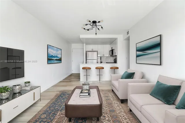 a living room with furniture a rug and a flat screen tv