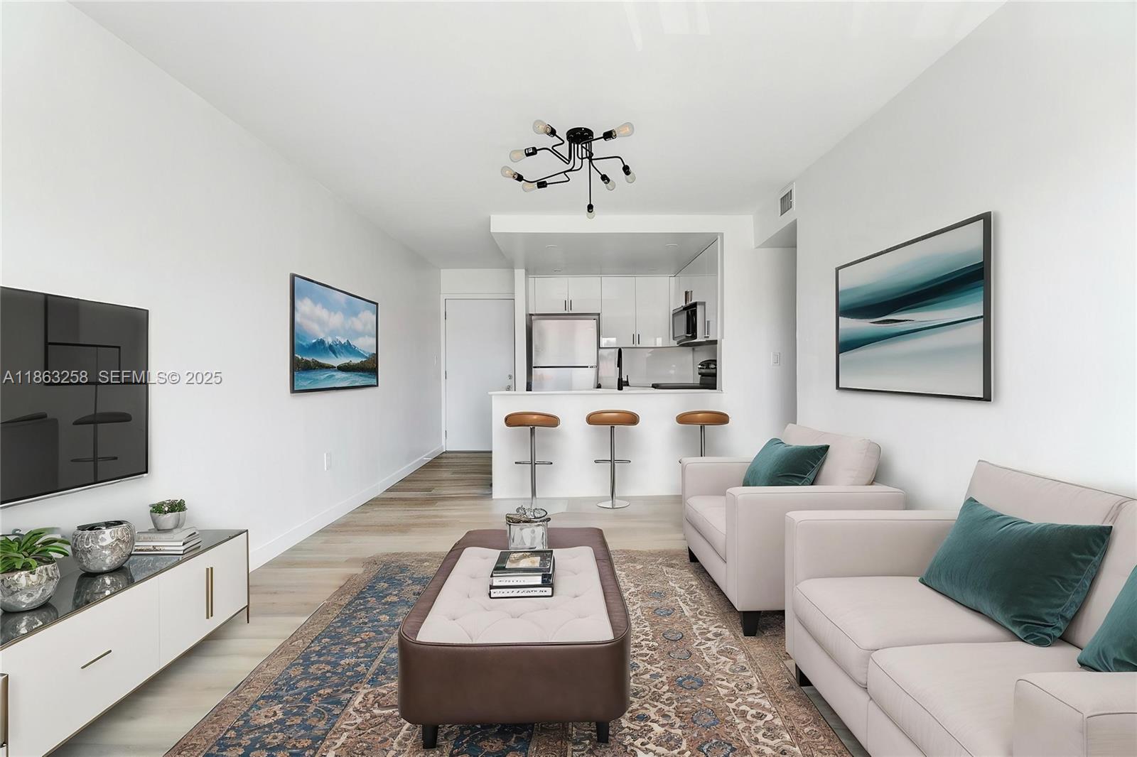 a living room with furniture a rug and a flat screen tv
