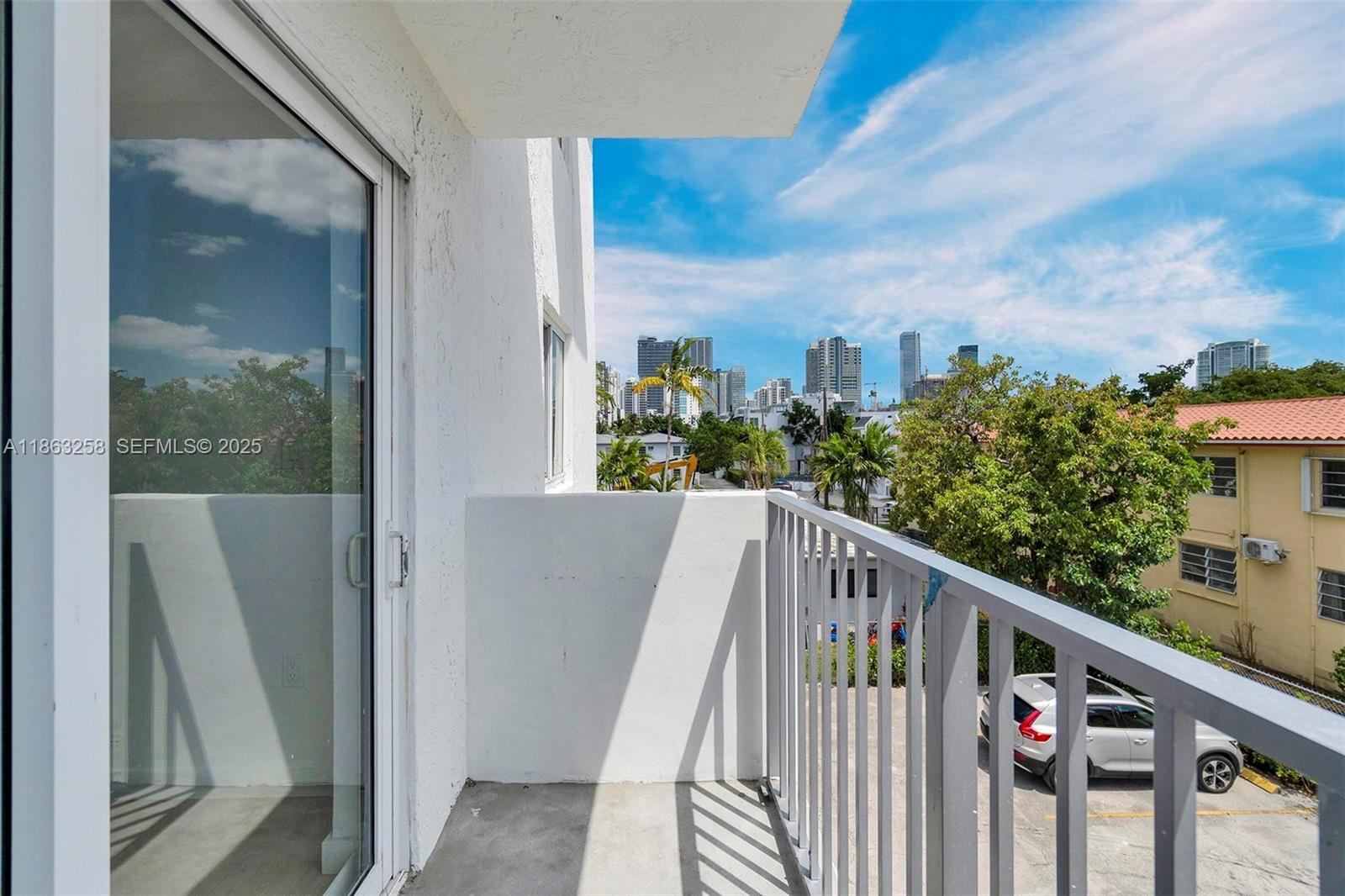 620 Southwest 10th Street, Unit 405 Miami, FL 33130 - Photo 11 of 21 a view of a balcony with wooden fence and floor