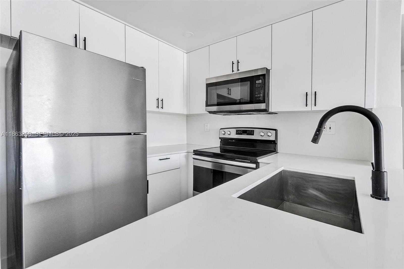 620 Southwest 10th Street, Unit 405 Miami, FL 33130 - Photo 3 of 21 a kitchen with a refrigerator and a sink