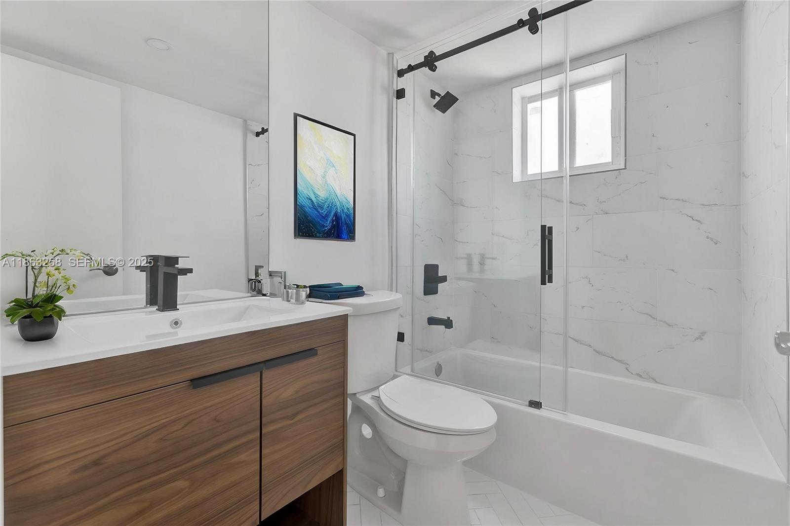 620 Southwest 10th Street, Unit 405 Miami, FL 33130 - Photo 10 of 21 a bathroom with a sink a toilet and shower