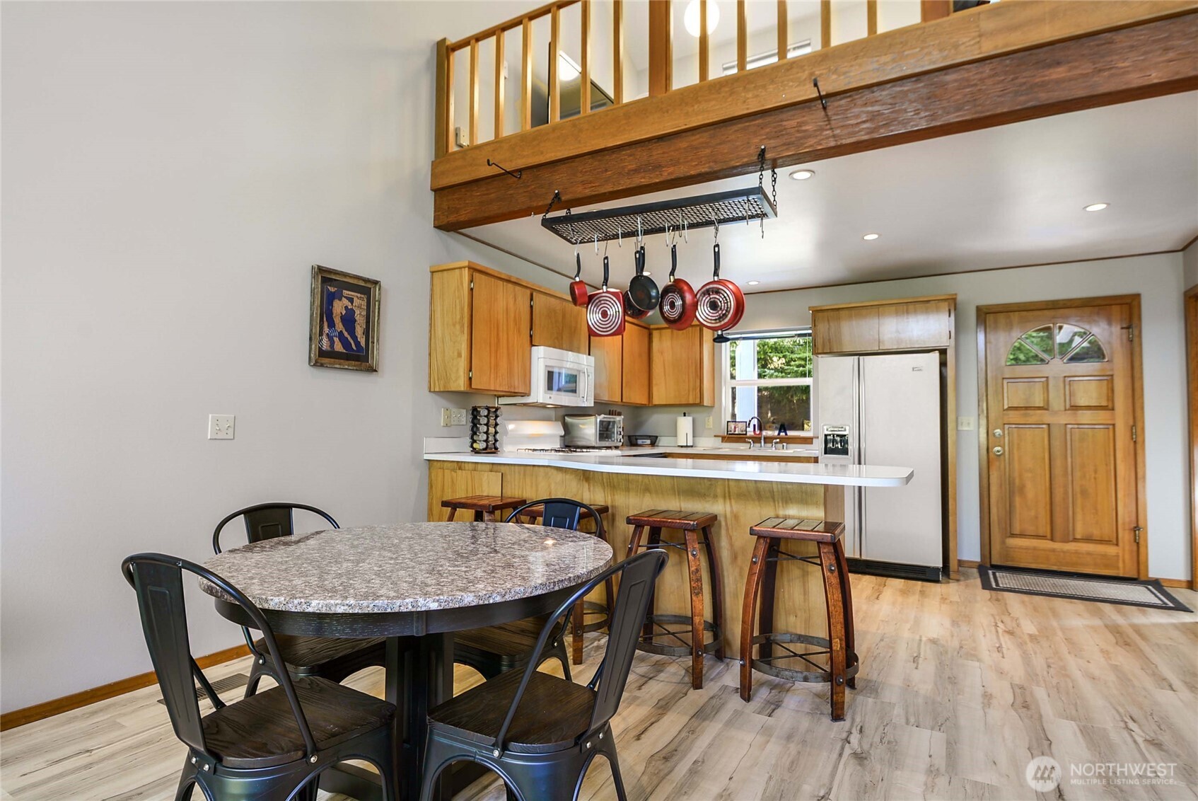2101 Wagner Road Camano Island, WA 98282 - Photo 12 of 36 a kitchen with stainless steel appliances granite countertop a kitchen island a stove a table and chairs