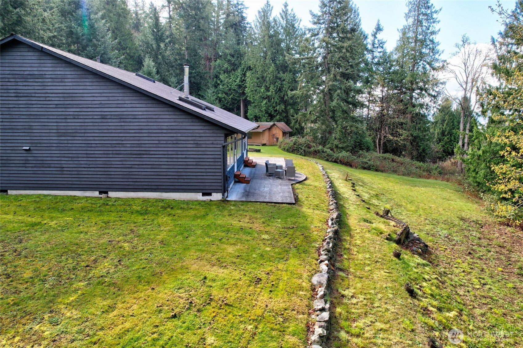 2101 Wagner Road Camano Island, WA 98282 - Photo 32 of 36 a backyard of a house with a garden and plants