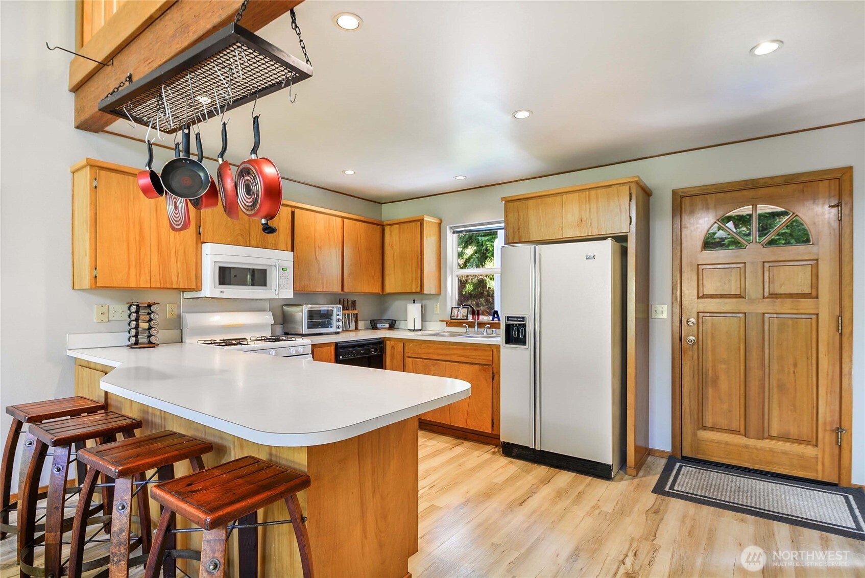 2101 Wagner Road Camano Island, WA 98282 - Photo 9 of 36 a kitchen with stainless steel appliances granite countertop a refrigerator a sink dishwasher and a stove with wooden cabinets