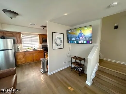 a kitchen with stainless steel appliances a refrigerator and a stove top oven
