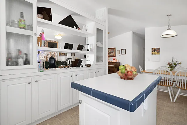a kitchen with a sink cabinets and wooden floor