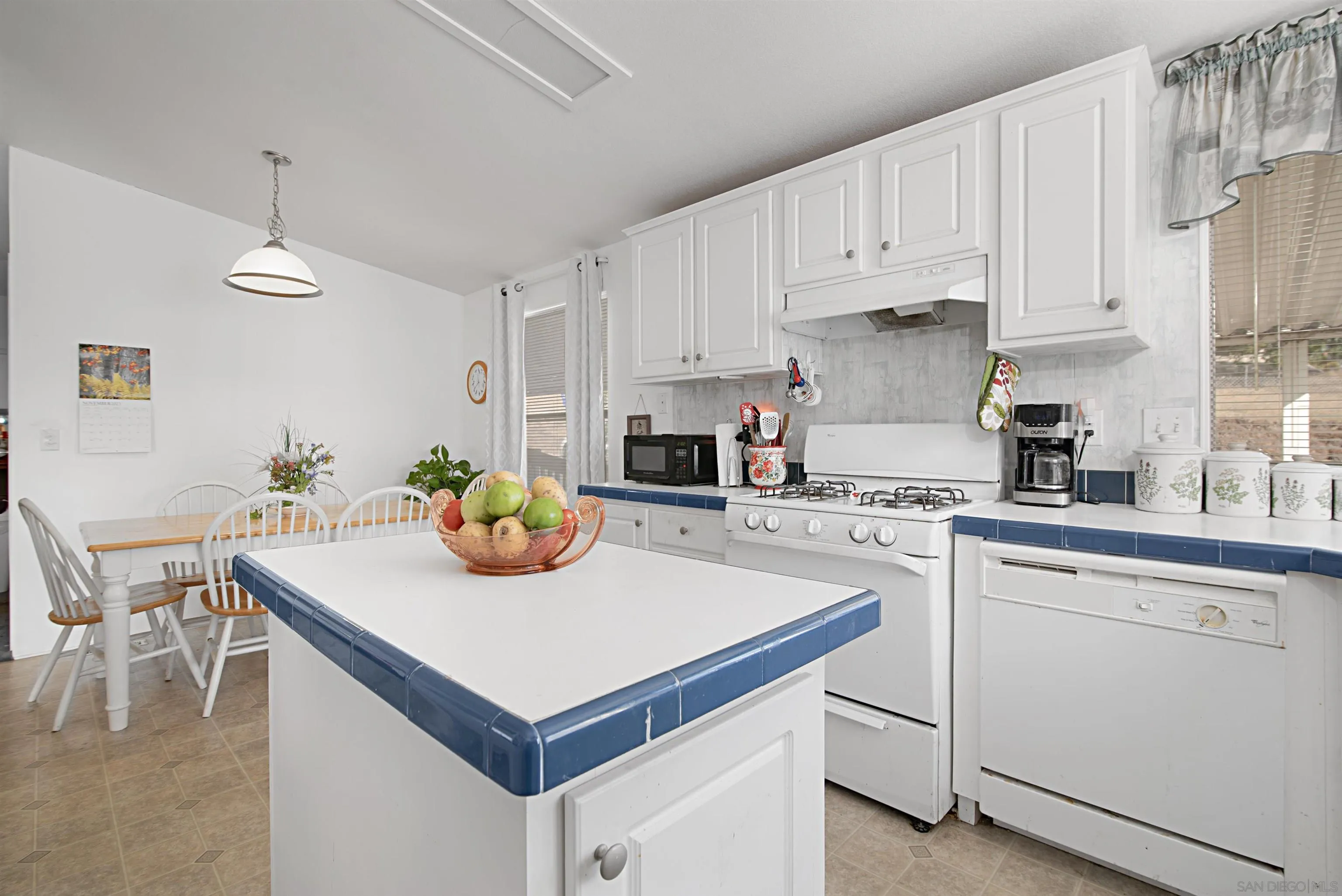 2030 Black Canyon Road, Unit 29 Ramona, CA 92065 - Photo 12 of 35 a kitchen with white cabinets and white appliances