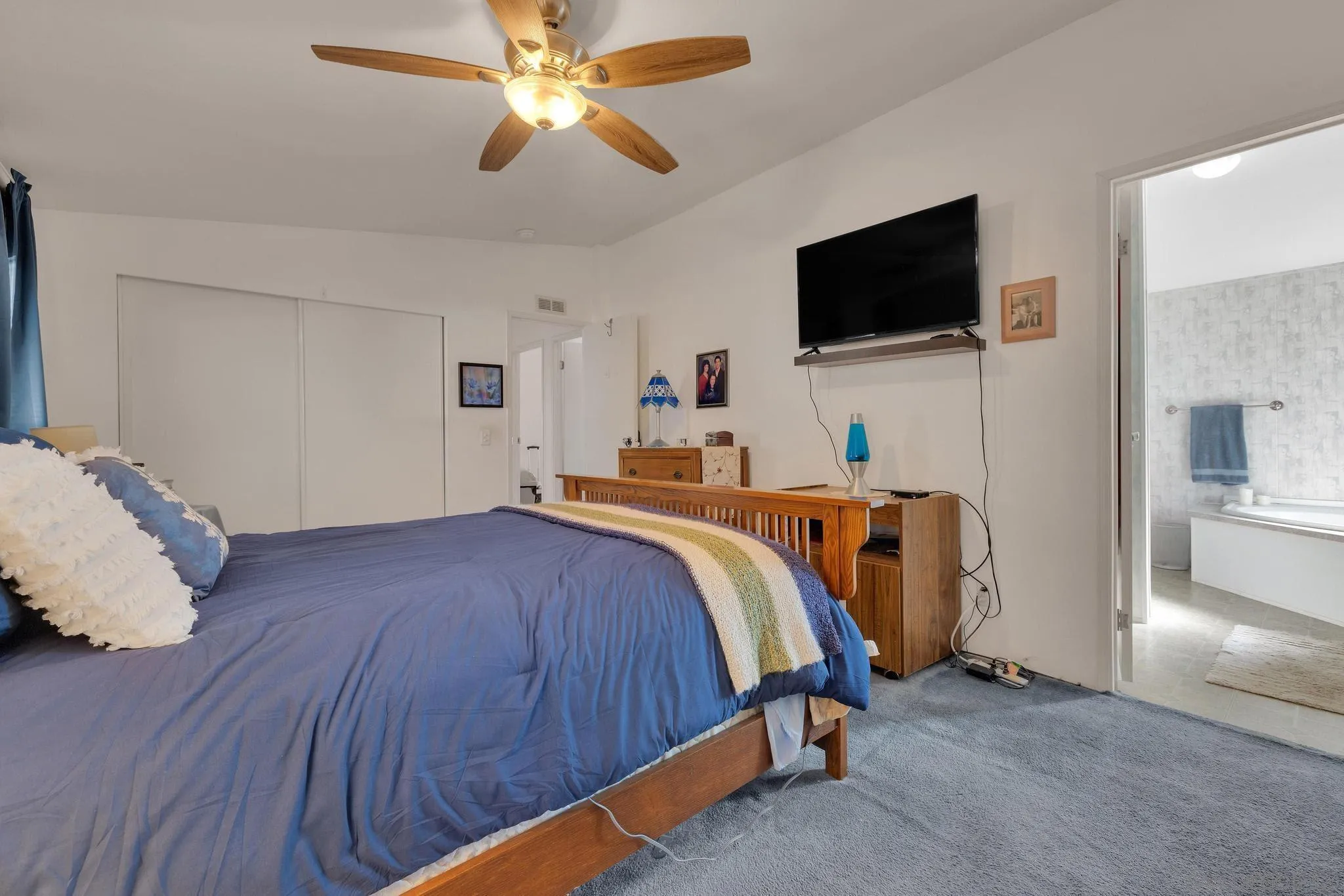 2030 Black Canyon Road, Unit 29 Ramona, CA 92065 - Photo 13 of 35 a bedroom with a bed and a flat screen tv