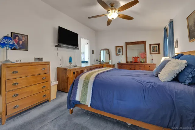 a bedroom with a large bed and a flat screen tv