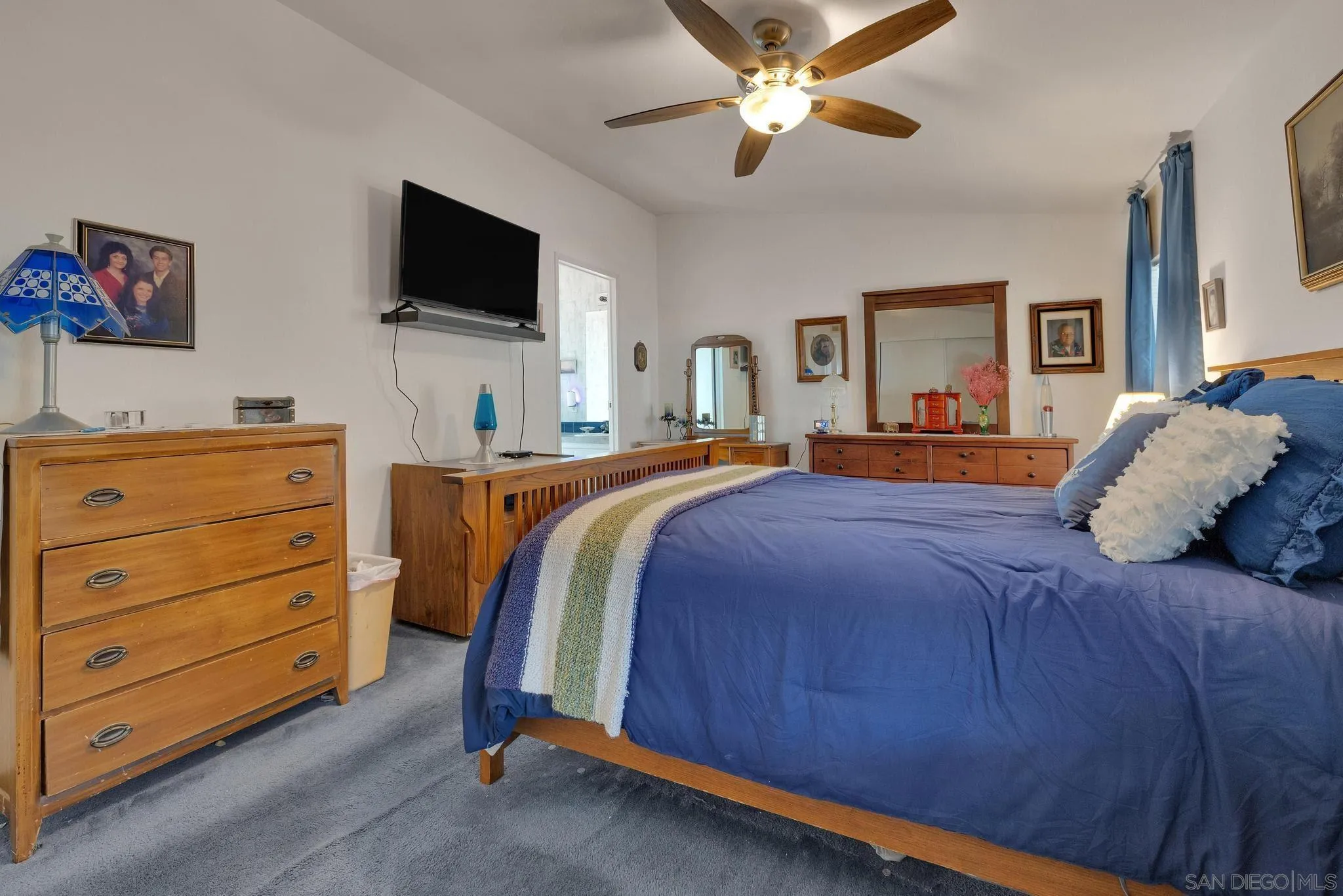 2030 Black Canyon Road, Unit 29 Ramona, CA 92065 - Photo 14 of 35 a bedroom with a large bed and a flat screen tv