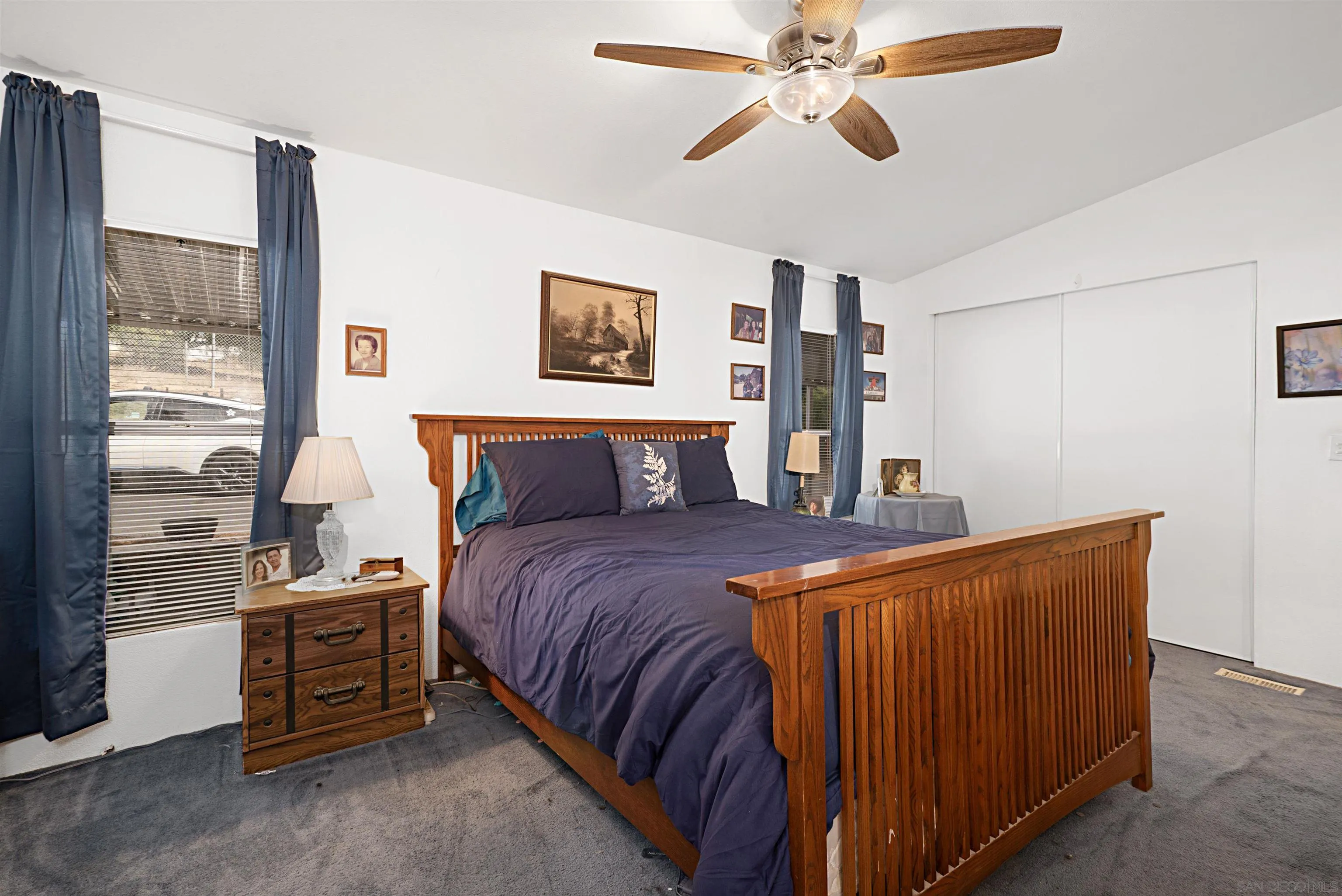 2030 Black Canyon Road, Unit 29 Ramona, CA 92065 - Photo 17 of 35 a bedroom with a bed and a chandelier