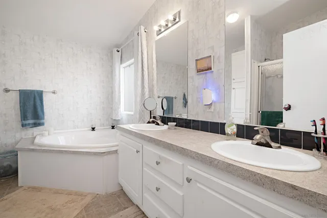 a bathroom with a double vanity sink mirror and double