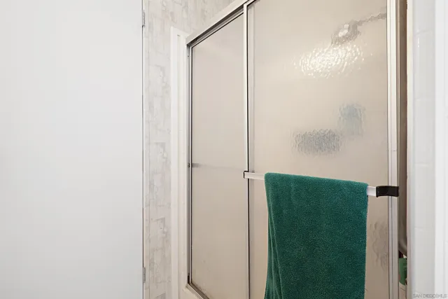 a bathroom with a shower and a mirror